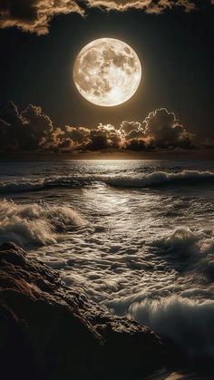 the full moon is shining brightly over the ocean and waves in front of it on a cloudy night