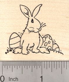 a rubber stamp with an image of a rabbit sitting next to eggs on the ground