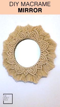 a circular mirror made out of yarn with the words diy macrame mirror