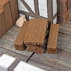 a wooden bench sitting on top of a floor next to a building with windows and shutters