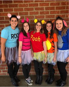 four girls dressed up as winnie the pooh