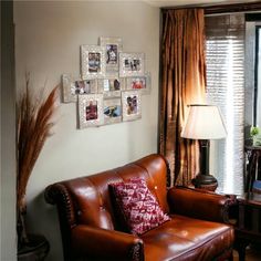 a living room with leather couches and pictures on the wall above them in front of a window