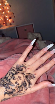 a woman's hand with a tattoo on it