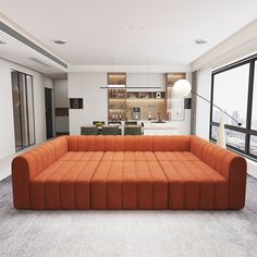 an orange couch sitting in the middle of a living room