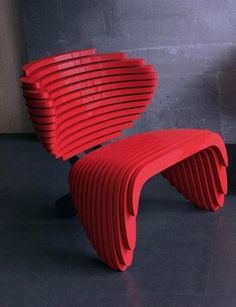 a red chair sitting on top of a black floor