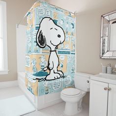 a shower curtain with a cartoon dog on it in a bathroom next to a toilet