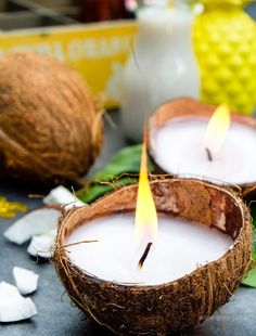 two coconuts with candles in them on a table