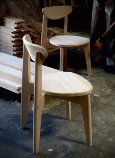 two wooden chairs sitting next to each other