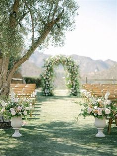 an outdoor ceremony set up with chairs and flowers