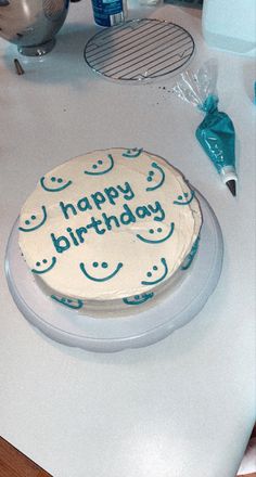 a birthday cake sitting on top of a counter next to a mixer and spatula