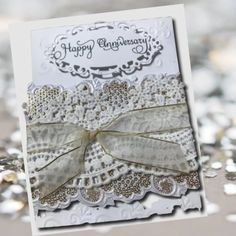 a close up of a happy anniversary card on a table with silver sequins