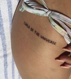 a close up of a person's stomach with the words child of the universe written on it