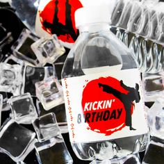 a bottle of kickin'birthday water sitting on top of some ice cubes