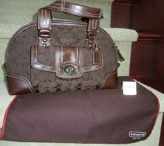 Coach Hampton Signature Brown leather Zip Double Handle Satchel Bag NWT F13977.  Retailed for $358.00.  I purchased it on sale for $269.00.    Bag Dimensions 13x8x5.  strap drop=7 Shipped with USPS Priority Mail. Designer Brown Satchel For Shopping, Coach Leather Satchel With Leather Trim, Designer Satchel With Leather Trim, Coach Satchel With Leather Trim For Travel, Coach Satchel With Leather Trim For Everyday Use, Coach Leather Trim Satchel For Travel, Coach Travel Satchel With Leather Trim, Classic Satchel With Leather Trim For Errands, Luxury Satchel With Leather Trim For Errands