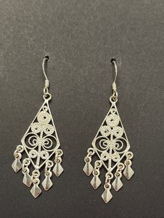 Delicate vintage sterling silver filigree earrings. So shiny and beautiful that they look like they are new. These are very lightweight and go with any outfit. The filigree work is exquisite and adds a touch of bling. Great for you or someone you love. Classic Filigree Dangle Chandelier Earrings, Classic Filigree Chandelier Earrings, Classic Filigree Chandelier Dangle Earrings, Classic Filigree Chandelier Earrings As Gift, Classic Filigree Chandelier Earrings For Gift, Ornate Filigree Earrings For Anniversary, Bohemian Filigree Earrings For Anniversary, Ornate 925 Stamped Silver Dangle Earrings, Ornate Silver Filigree Earrings