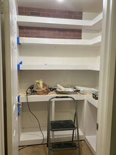 an empty room with shelves and ladders in it