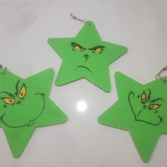 three green stars with faces drawn on them