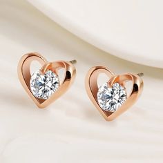 Cubic Zirconia Heart Earrings Rose gold tone heart earrings with a large beautiful and fiery cubic zirconia accent in the middle. Approximately 1/2" x 1/2". New in package, no tag. Jewelry Earrings Rose Gold Heart Cut Earrings, Rose Gold Cubic Zirconia Heart Cut Earrings, Rose Gold Heart-shaped Cubic Zirconia Earrings, Rose Gold Heart Pendant Earrings For Anniversary, Rose Gold Heart Earrings For Anniversary, Rose Gold Cubic Zirconia Heart Earrings For Valentine's Day, Rose Gold Heart Earrings, Rose Gold Cubic Zirconia Heart Earrings For Anniversary, Valentine's Day Rose Gold Heart Earrings With Cubic Zirconia