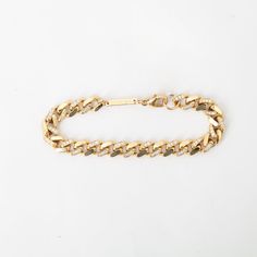 This one might ﻿actually﻿ be the baddest of them all. Thick gold links are accented with pavé diamonds for a heavy metal look that's effortlessly elegant. Wear it alone to elevate any look day or night, or stack it with your favorite bracelets for a stunning play of metals and textures. Made in the U.S.A. Measures 6.5" long and 7 mm wide. 14 karat yellow goldset with approximately 0.72ctw white diamonds. Diamond Chain Link Bracelet With Curb Chain, Luxury Gold Diamond Cuban Link Bracelet, Luxury Cuban Link Metal Bracelet For Formal Occasions, Luxury Metal Curb Chain Bracelet, Diamond-encrusted Yellow Gold Chain Link Bracelet, Yellow Gold Diamond Chain Link Bracelet, Diamond Chain Link Gold Bracelet In Yellow Gold, Luxury Yellow Gold Cuban Link Diamond Bracelet, Diamond Chain Link Bracelets