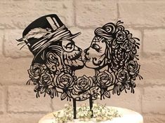 a cake topper with an image of two people kissing each other on it's side