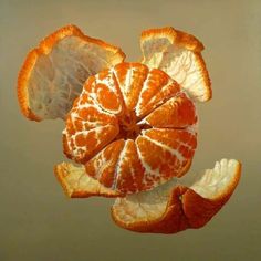 an orange cut in half sitting on top of a table