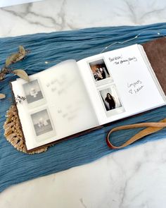 an open book sitting on top of a table next to a pair of scissors and other items