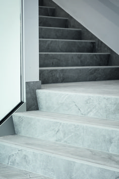 the stairs are made of marble and have metal handrails