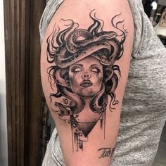 a woman with a snake on her head and an octopus around her neck is depicted in this tattoo design