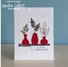 a card with three vases and leaves on the bottom one is red, the other is white