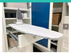 an ironing board sitting on top of a cabinet