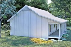 a small white shed sitting on top of a lush green field