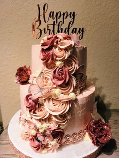 a birthday cake decorated with pink flowers and butterflies