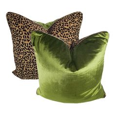 two pillows with leopard print on them, one in green and the other in brown