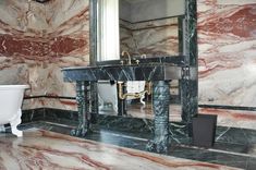 a bathroom with marble walls and flooring