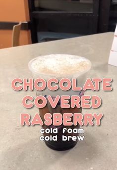 chocolate covered raspberry cold drink in a plastic cup on a counter top with the words, chocolate covered raspberry cold beverage