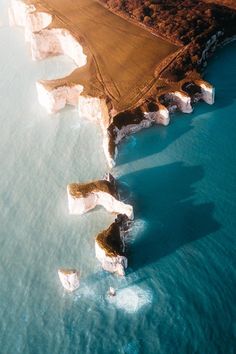 an aerial view of some white cliffs in the water