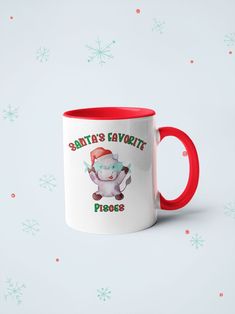 a white and red coffee mug with santa's favorite phrases on it, sitting in front of snowflakes