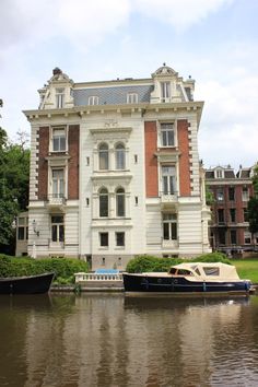 two boats are parked in front of a large building