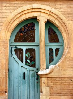 a green door with two arched glass windows