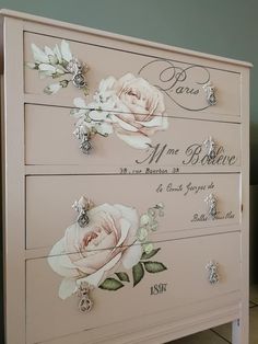 a pink dresser with flowers painted on it