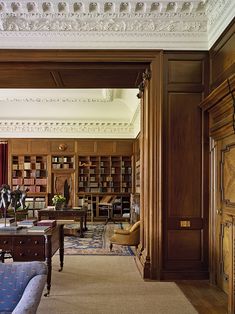 a living room filled with furniture and bookshelves