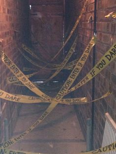 caution tape is taped around the entrance to an underground tunnel that has been closed for several years