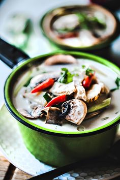 a green bowl filled with food on top of a table