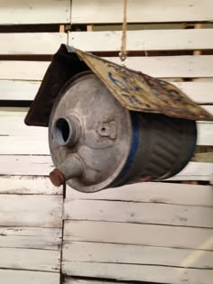 an old metal birdhouse hanging from the ceiling