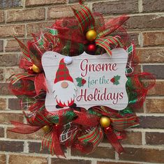 a christmas wreath on the side of a brick wall with gnome for the holidays written on it