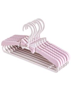 a set of pink clothes hangers with bows on each one and two rows of them