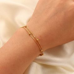 The Gemma Double Satellite Bracelet is a great layering piece, it is dainty but still makes a statement! With a youthful and contemporary feel, this adorable bracelet is a must-have for your stacking bracelet collection. Chain Length: 6 3/4" with a 1 1/4" extender 18K Gold Plated Stainless Steel Double Satellite Chain Water and Tarnish Resistant: Crafted to withstand everyday wear and tear Hypoallergenic: Made with high-quality materials and is safe for those with sensitive skin. Double Chain Bracelet Gold, Delicate Bracelets For Layering, Delicate Layering Bracelets, Trendy Adjustable Charm Bracelet With Delicate Chain, Trendy Charm Bracelet With Delicate Chain, Dainty Delicate Chain Bracelets For Layering, Delicate Chain Bracelet For Layering, Dainty Bracelets For Layering, Trendy Adjustable Delicate Chain Bracelet