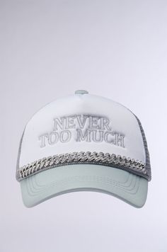 a white baseball cap with the words never too much printed on it