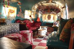 a living room filled with lots of furniture and decor on top of a checkered floor