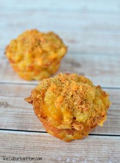 two small muffins sitting on top of a wooden table